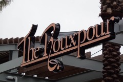 The Rouxpour overhang sign closeup view